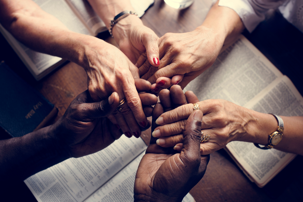 Group of adults holding hands for worship