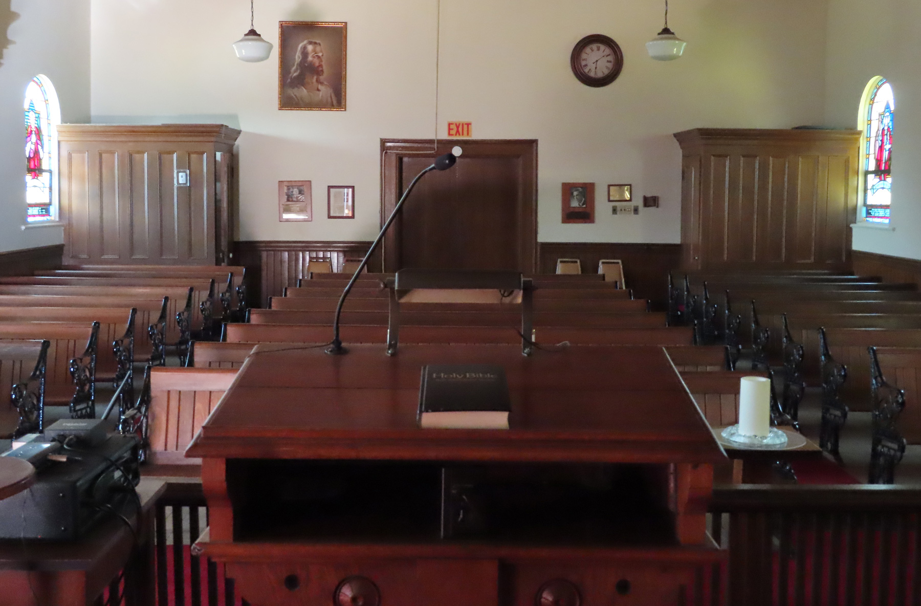 View from pulpit of bible resting on altar with pews in the background