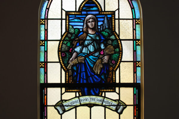 Stained glass window depicting Ruth holding a sheaf of wheat